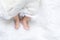 Cute newborn baby foot girl in white blanket onÂ nurseryÂ bed.AdorableÂ new born child people Family.